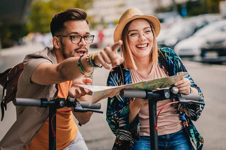 A couple exploring Krakow on e-scooters